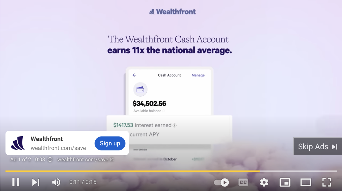 An interactive ad for a wealth management app on a YouTube video with a CTA to 'sign up' demonstrates an increase of personalization in PPC advertising
