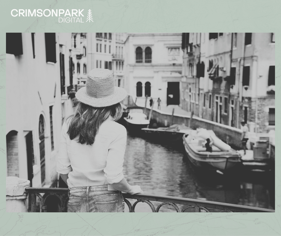 A woman looks out over a canal while on vacation